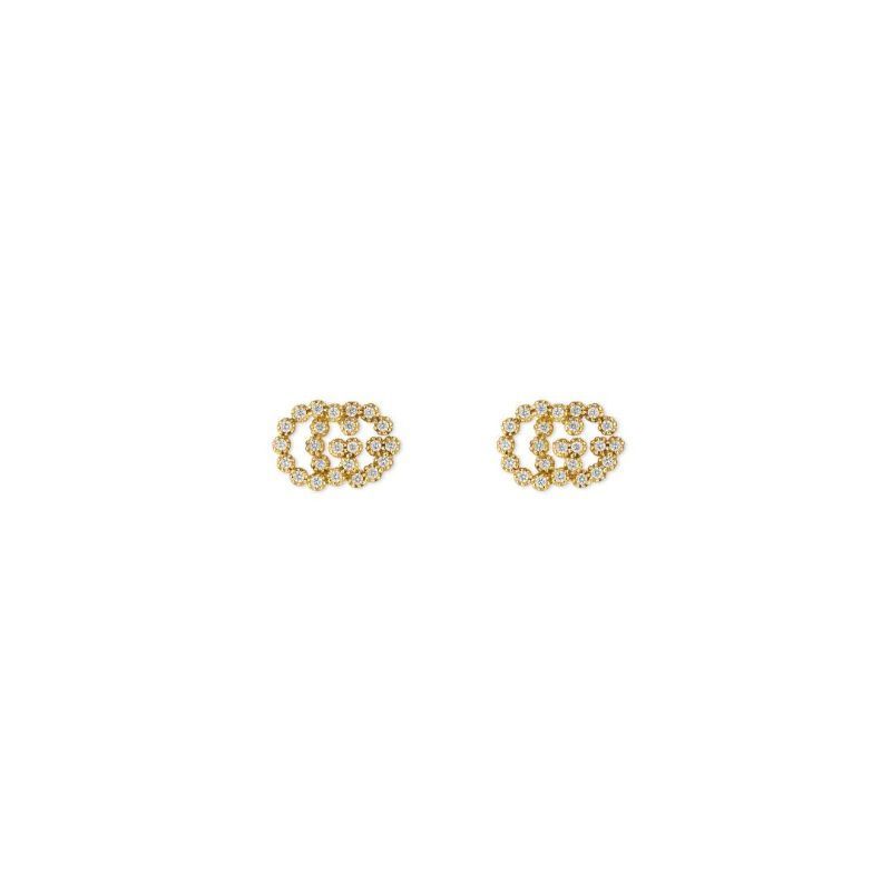 A pair of Gucci GG Running 18K Yellow Gold Diamond Stud Earrings from GUCCI Fine Jewellery features a circular interlocking design embedded with tiny, brilliant diamonds, all set against a plain white background.