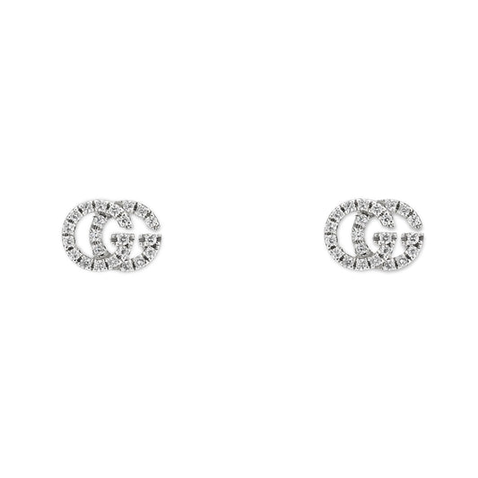 Presenting the Gucci GG Running 18K White Gold Diamond Stud Earrings by GUCCI Fine Jewellery, these elegant earrings are designed in the shape of interlocking "G" letters and are adorned with small sparkling diamonds, beautifully showcased against a plain white background.