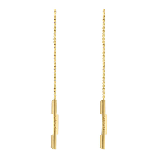 Introducing the Gucci Link To Love 18K Yellow Gold Chain Drop Earrings by GUCCI Fine Jewellery. These earrings present a sleek, minimalist design, featuring a delicate chain drop and a straight bar engraved with "Gucci," perfectly aligned to highlight their elegant simplicity.