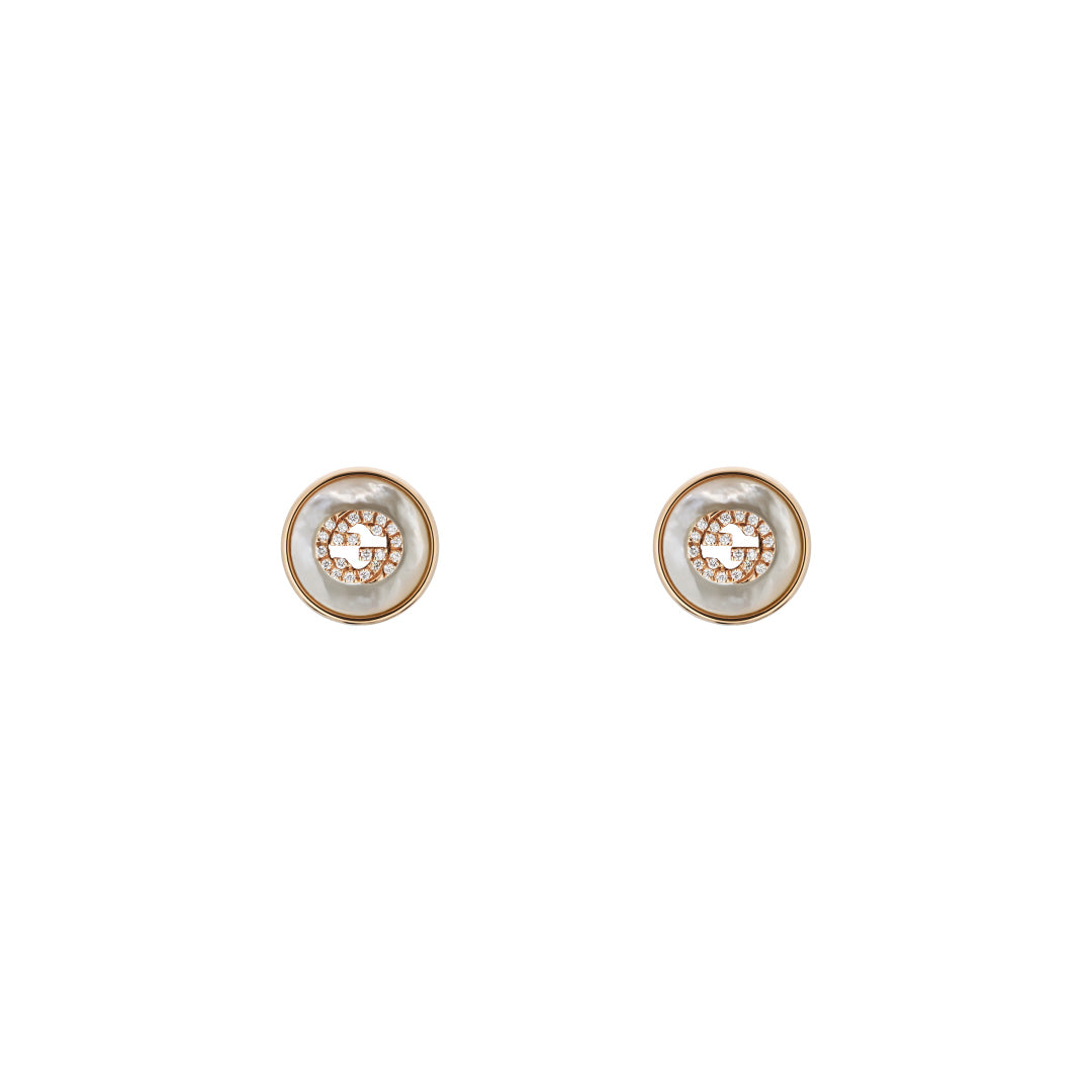 Introducing the Gucci Interlocking 18K Rose Gold Diamond Stud Earrings by GUCCI Fine Jewellery, featuring a round design with a rose gold outer rim and a white center adorned with intricate patterns. These elegant earrings embody the prestigious standards of the Responsible Jewelry Council.