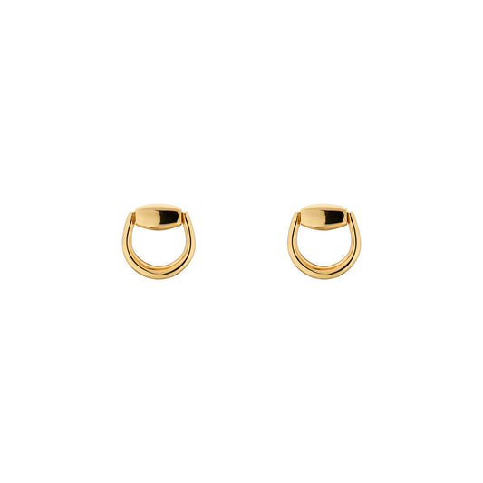 A pair of Gucci Horsebit 18K Yellow Gold Stud Earrings shines brilliantly against a white background. These elegant accessories from the GUCCI Fine Jewellery collection feature a simple yet sophisticated design with a smooth, shiny finish.