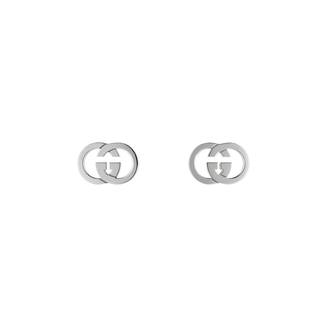 The Gucci Interlocking Sterling Silver Stud Earrings by GUCCI Fine Jewellery feature interlocking double G logos and are shown on a plain white background.
