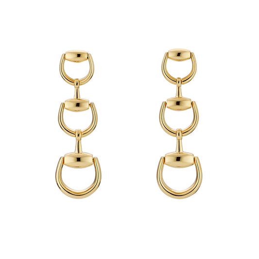 The Gucci Horsebit 18K Yellow Gold Drop Earrings by GUCCI Fine Jewellery feature three vertically linked U-shaped and oval elements, creating a modern, elegant design in fine 18k yellow gold.