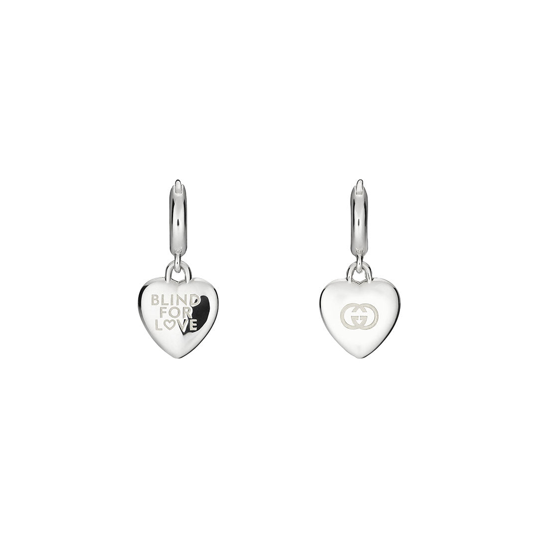 The Gucci Blind for Love Sterling Silver Hoop Earrings from GUCCI Fine Jewellery feature one hoop engraved with "BLIND FOR LOVE" and the other with an interlocking double G logo, adding a chic romantic touch to any look.