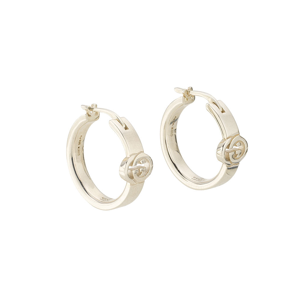 A pair of Gucci Interlocking G Hoop Sterling Silver Earrings from GUCCI Fine Jewellery, each featuring a bold double-G logo, displayed on a plain white background.