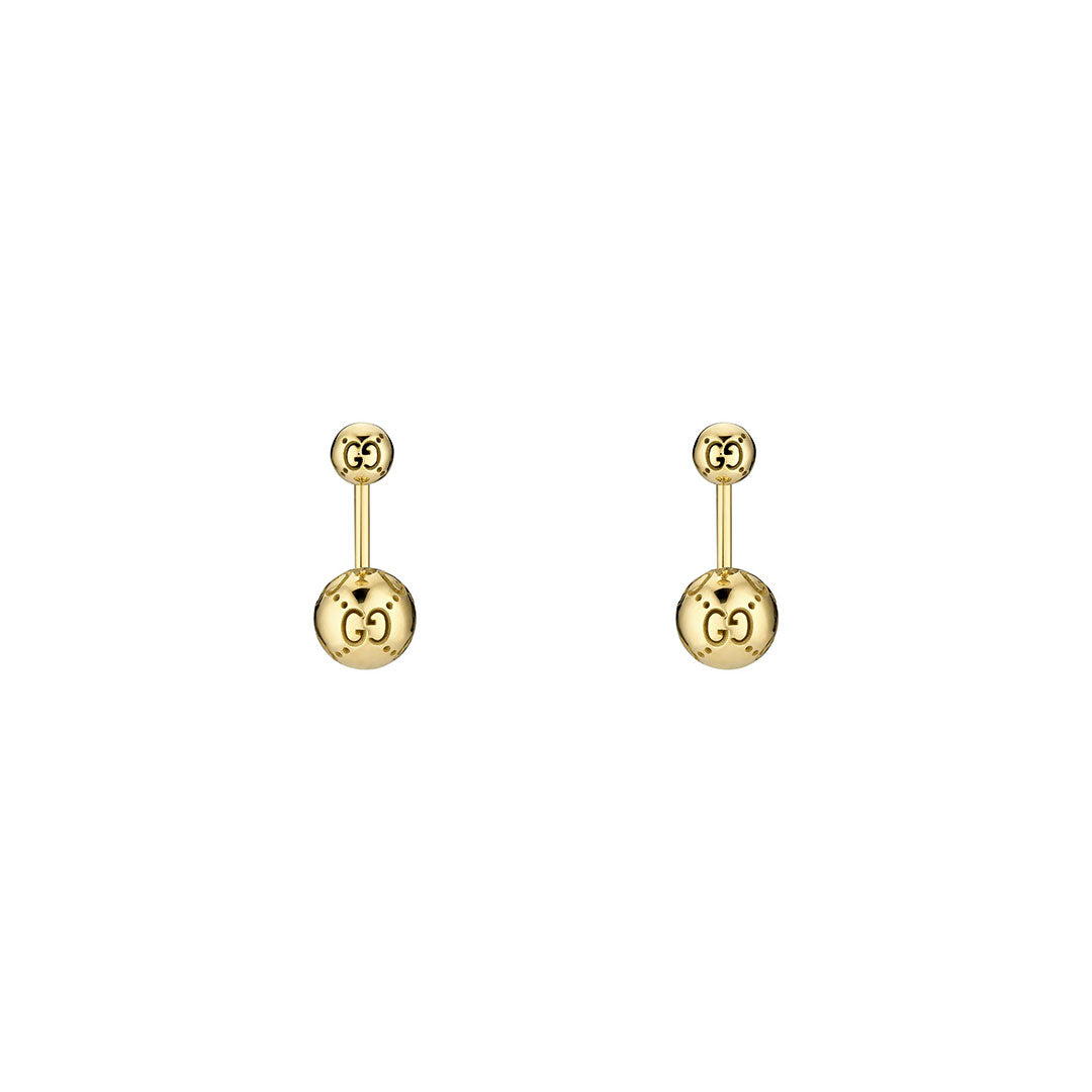 The Gucci Icon Boule 18K Yellow Gold Jacket Earrings by GUCCI Fine Jewellery feature the interlocking GG logo on both the round stud and larger sphere, offering a minimalist, elegant look that complements a classic gold ring.