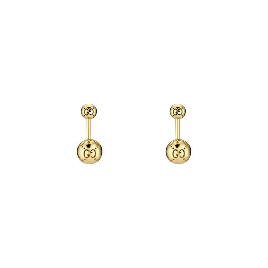 The Gucci Icon Boule 18K Yellow Gold Jacket Earrings by GUCCI Fine Jewellery feature the interlocking GG logo on both the round stud and larger sphere, offering a minimalist, elegant look that complements a classic gold ring.