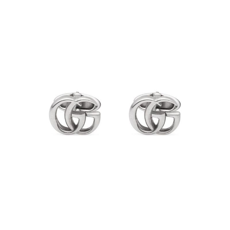 The Gucci GG Marmont Cufflinks by GUCCI Fine Jewellery feature an interlocking design, reminiscent of two overlapping loops. These cufflinks boast a sleek and polished appearance with a metallic finish, crafted from 925 sterling silver for enduring elegance.