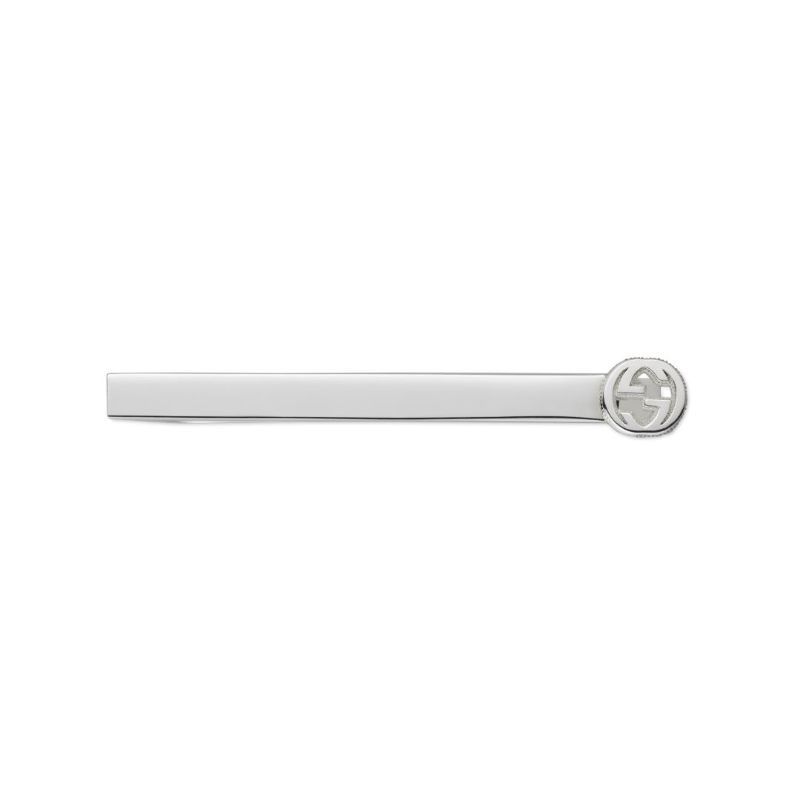 The Gucci Interlocking G Tie Bar by GUCCI Fine Jewellery is crafted from sterling silver and features a round emblem with interlocking "G" letters on the right end.
