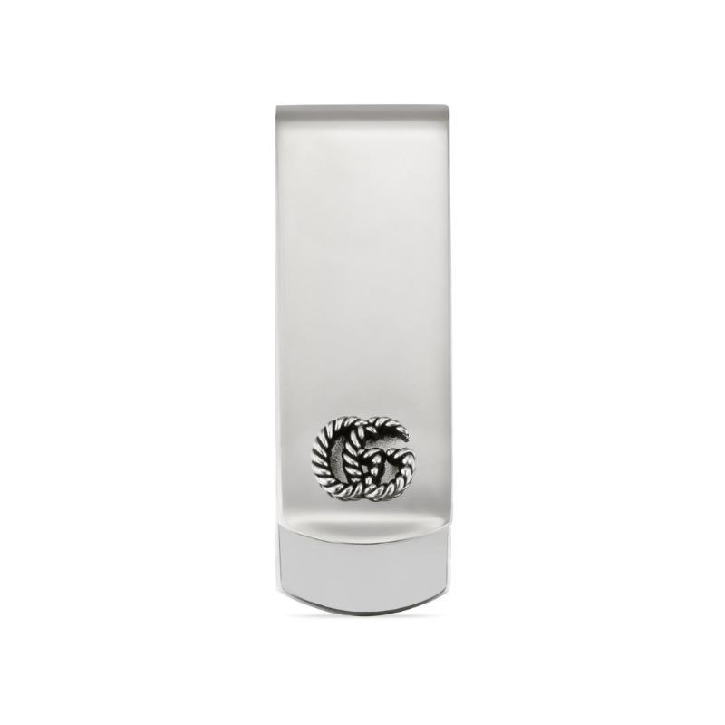 A tall, minimalist, rectangular object with a smooth, white surface. Near the bottom center is a black circular design resembling a fern or feather pattern, subtly echoing the elegance of the Gucci GG Marmont Money Clip by GUCCI Fine Jewellery.