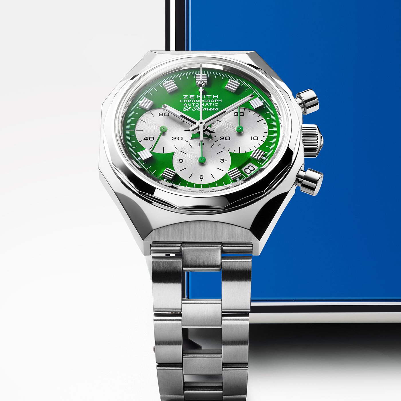 The Zenith Defy Chronograph USM - USM Green by Zenith features a green and white dial, silver markers, and three subdials powered by the El Primero 400 calibre, set against a white and blue geometric background.
