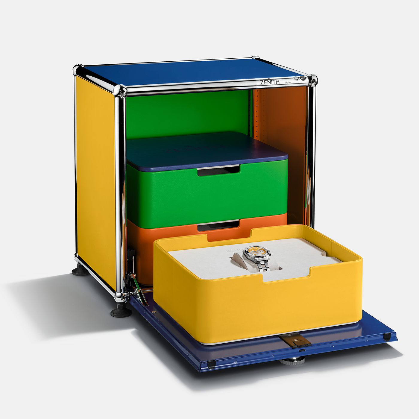 Showcase your Zenith Defy Chronograph USM - Golden Yellow in style with this colorful storage box featuring yellow, green, and orange drawers (one open to reveal the watch), a blue top and base, and chrome frame accents.