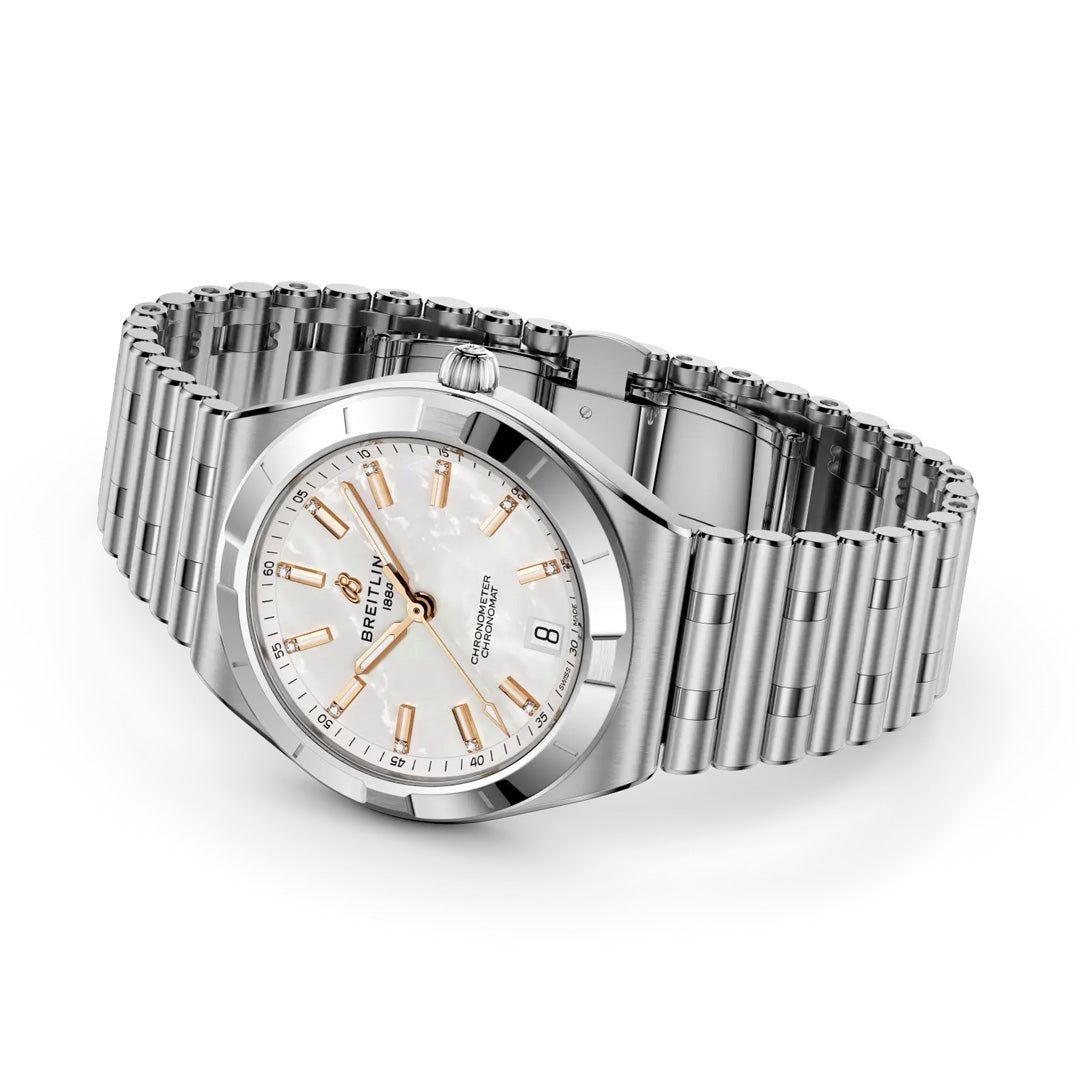 The BREITLING Chronomat Automatic 36 is a stainless steel sports watch with a silver link bracelet, white dial, gold markers and hands, COSC-certified movement, and date window at 6 o’clock, shown on a white background.