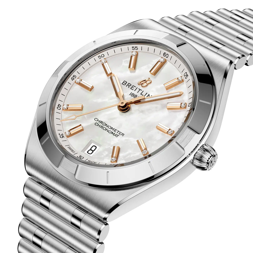 A close-up of the Breitling Chronomat Automatic 36, featuring a silver metal band, white mother-of-pearl dial, gold hour markers, date window at 6 o’clock, and COSC-certified chronometer inscription on the face.