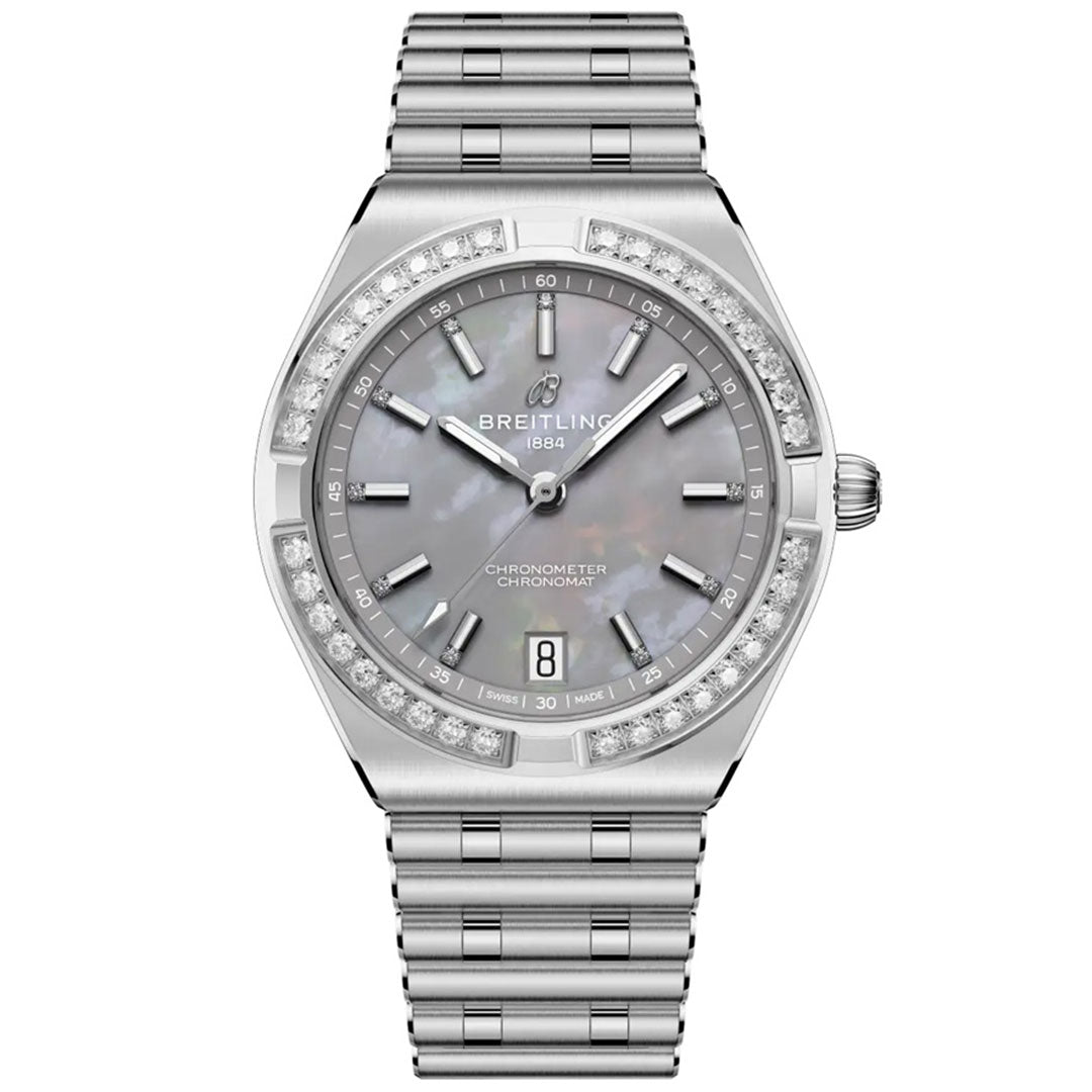 The BREITLING Chronomat Automatic 36 is a luxury sports watch featuring a silver metal band, diamond-accented bezel, gray mother-of-pearl dial, silver hour markers, date at 6 o’clock, and Breitling logo at 12 o’clock.