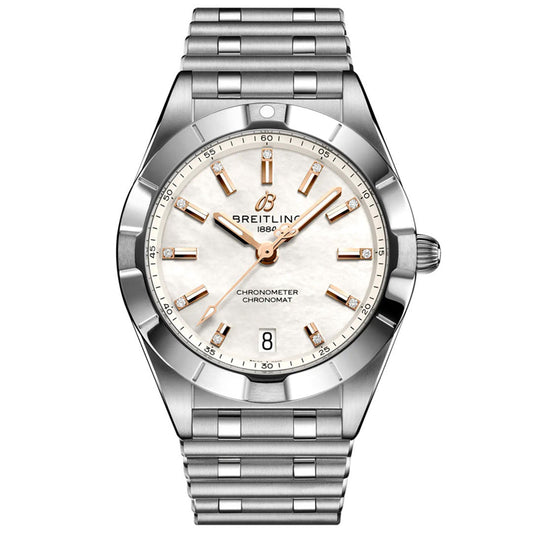 The BREITLING Chronomat 32 features a silver metal band, white dial, gold-tone markers and hands, diamond-set bezel, date at 6 o’clock, and displays the Breitling logo with “1884” below the 12 o’clock marker.