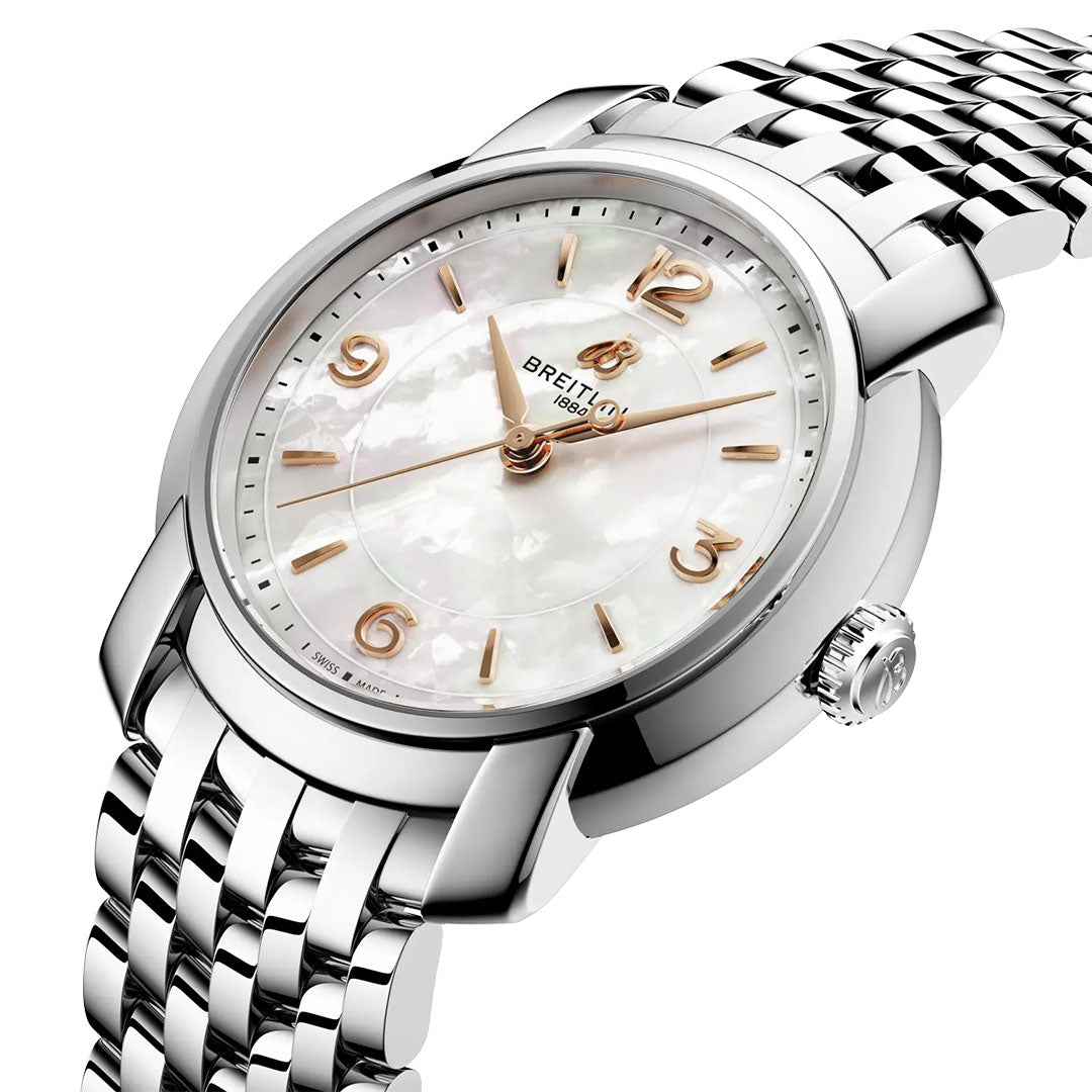 A close-up of the BREITLING Lady Premier 32 women’s watch shows its silver metal band, white mother-of-pearl dial with gold hour markers and hands, brand logo, and crown.
