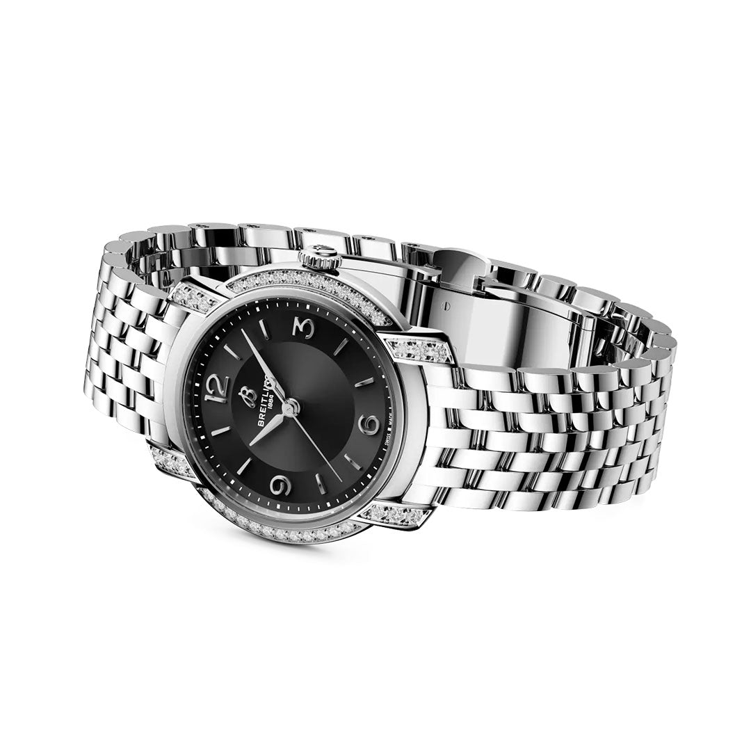 The BREITLING Lady Premier 32 by Breitling is a silver women’s watch with a black face, silver hour markers, diamond-accented bezel, metal link band, and displays hour, minute, and second hands.