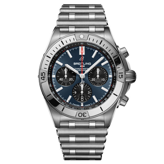 The BREITLING Chronomat B01 42 is a silver Breitling watch with a black dial that features three sub-dials, white hour markers, and a red second hand. This mechanical chronograph includes a tachymeter scale on the bezel and is finished with a metal link bracelet.