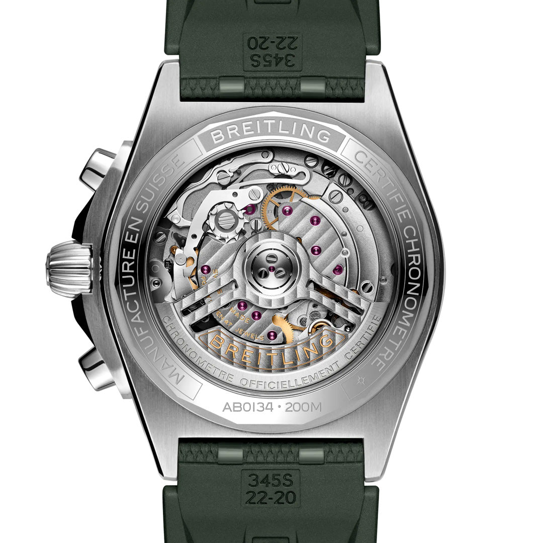 The image showcases the back of a luxury BREITLING Chronomat B01 42, revealing its intricate Breitling Manufacture Caliber 01 mechanical movement. It features detailed engravings on the metal case back and is elegantly paired with a green strap.