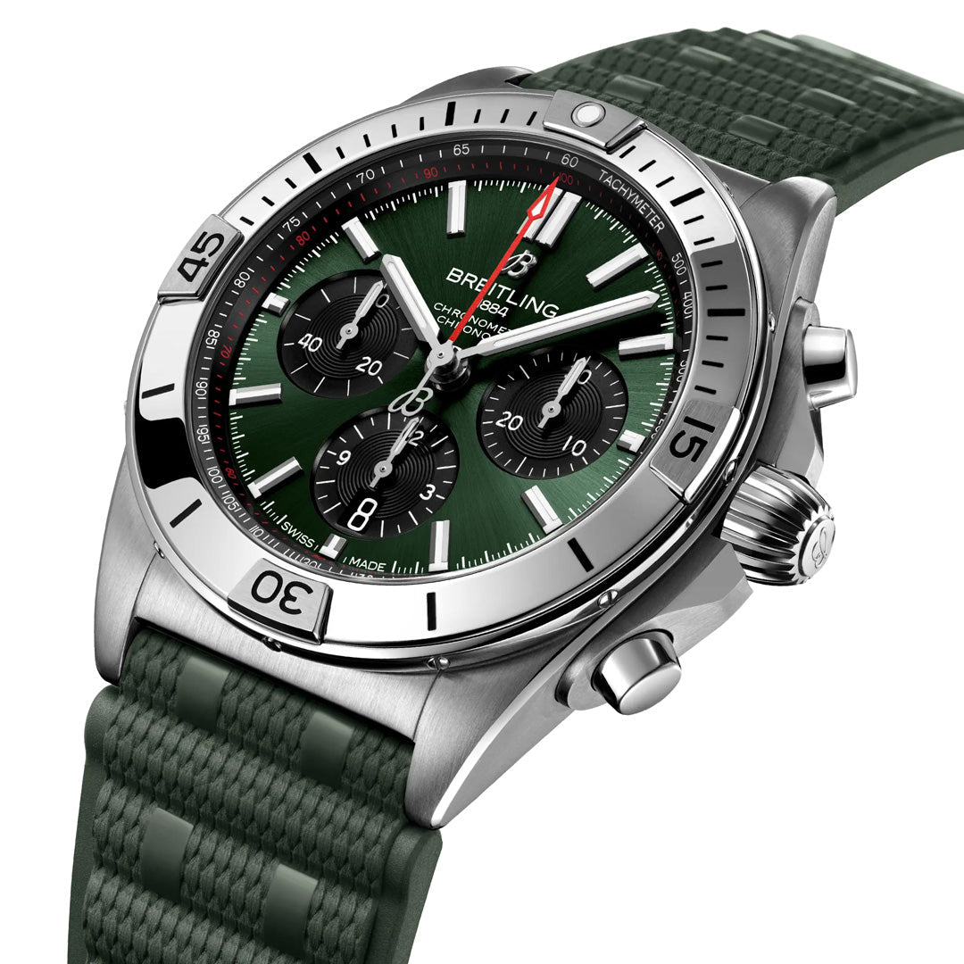 The BREITLING Chronomat B01 42 features a green dial with a matching rubber strap, three subdials, date display, and tachymeter bezel. Its stainless steel case houses the Breitling Manufacture Caliber 01 mechanical chronograph for precise timekeeping.