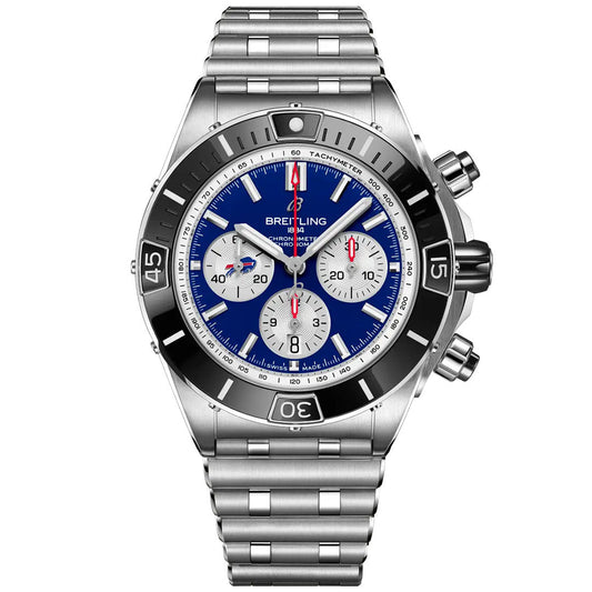 The Breitling Super Chronomat B01 NFL Buffalo Bills Edition is a stainless steel luxury sports watch with a blue dial, three subdials, silver hour markers, black bezel, metal bracelet, and red-accented hands.