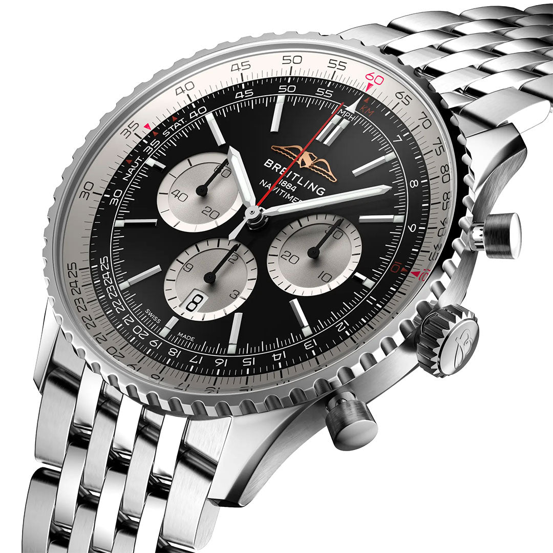 A close-up of the Breitling Navitimer B01 Chronograph 46 shows its black dial, three silver subdials, date display, stainless steel bracelet, and detailed bezel with red and white accents—a luxury pilot’s chronograph by Breitling.