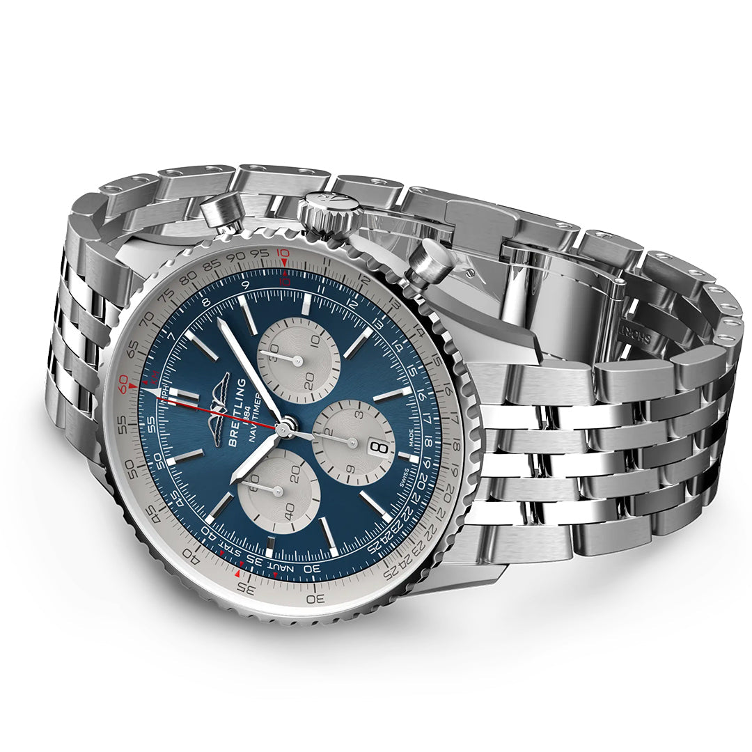 The BREITLING Navitimer B01 Chronograph 46 is a luxury aviation watch with a silver metal bracelet and dark blue dial, featuring three chronograph dials. It has a tachymeter scale on the rim, resembling the signature design of Breitling, and includes two pushers and a crown on the side.