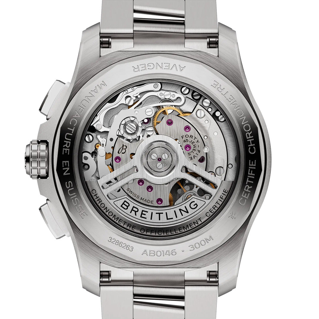 The image displays the back of a stainless steel Breitling Avenger B01 Chronograph 42, revealing its intricate mechanical movement through a transparent case back. "Manufacture en Suisse" and "Chronometre Officiellement Certifie" are engraved around the edge, highlighting its aviation style essence.