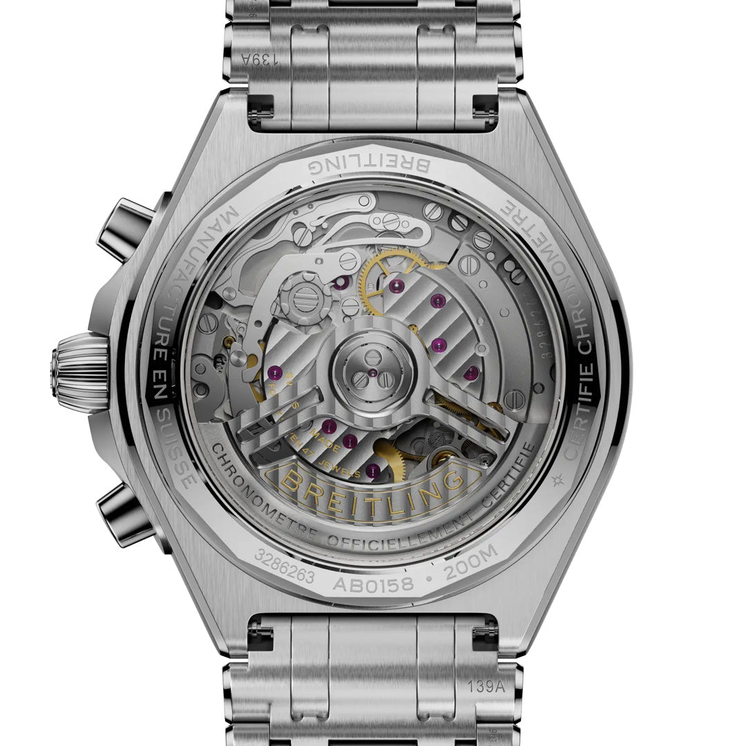 Close-up of the back of the BREITLING Chronomat B01 Chronograph 42, revealing its transparent case with detailed engravings and a view of the intricate mechanical chronograph movement and gears by Breitling.