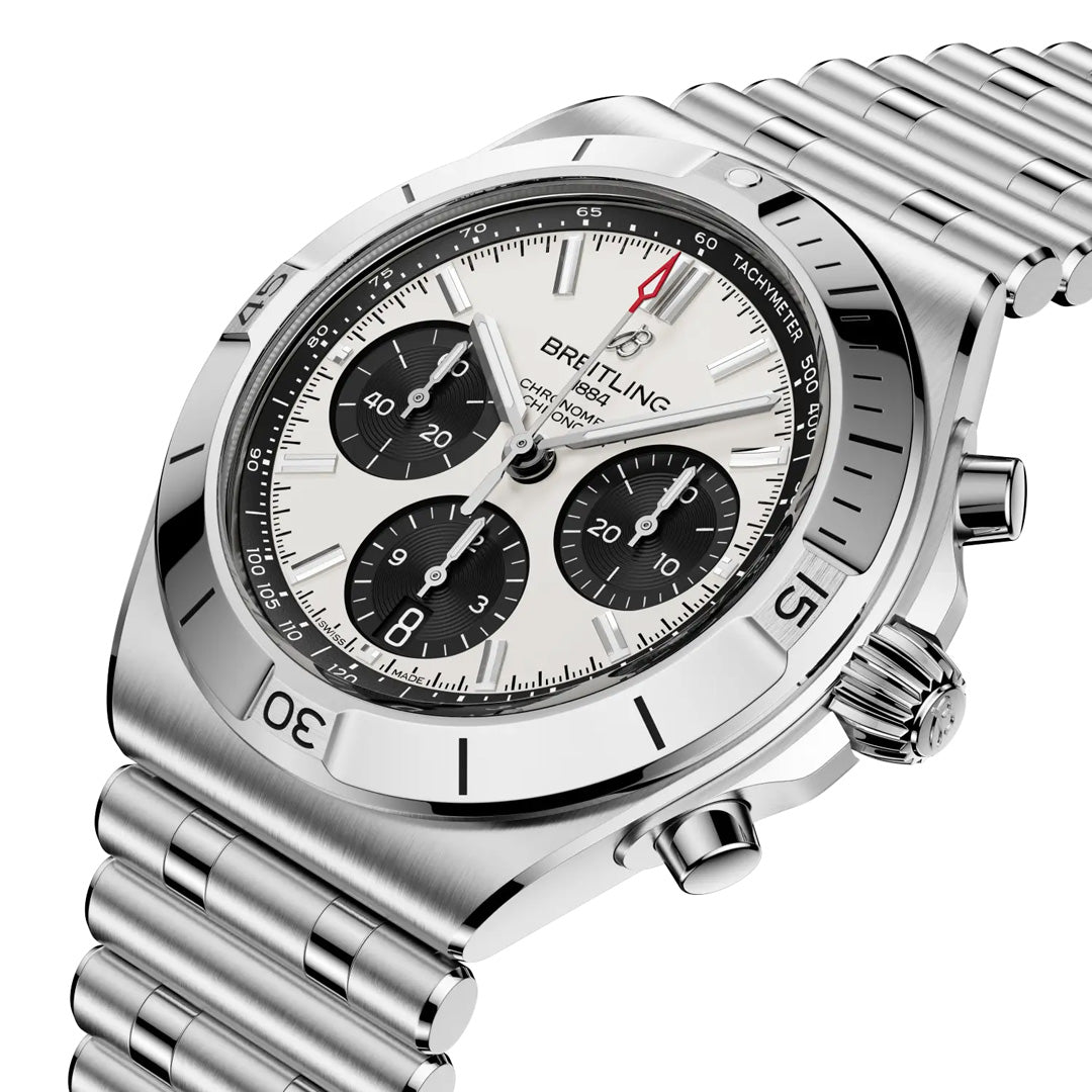 The Breitling Chronomat B01 Chronograph 42 features a silver case, white dial with three black subdials, tachymeter scale, and stainless steel bracelet, shown angled against a white background.