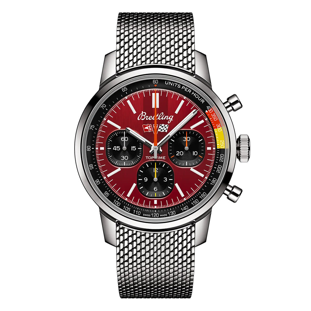 The BREITLING Top Time B01 Chevrolet Corvette is a sophisticated chronograph watch featuring a red dial with three subdials, a tachymeter scale with colorful accents, and a metallic mesh strap. With prominent pushers and crown, it proudly displays the Breitling name, evoking the spirit of a Chevrolet Corvette.