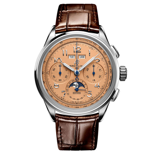 The BREITLING Premier B25 Datora 42 luxury watch features a brown leather strap paired with a polished silver case. Its copper-colored dial is adorned with multiple subdials, a moon-phase indicator, and a date window, elegantly displaying the Breitling brand name.