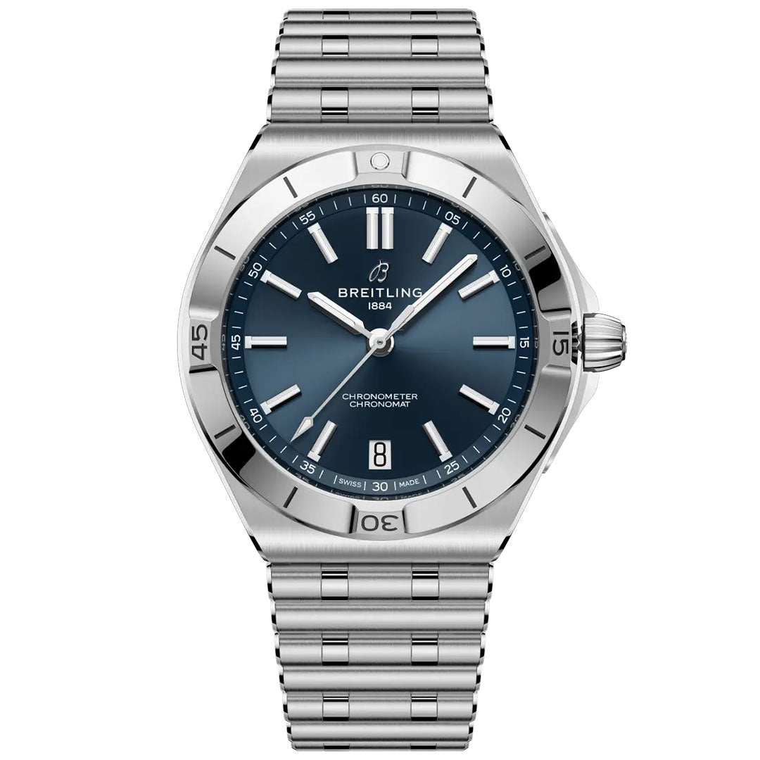 The BREITLING Chronomat B31 40 is a stainless steel watch with a blue dial, silver markers, date window at 6 o’clock, COSC-certified chronograph, Breitling logo, and signature Rouleaux bracelet.