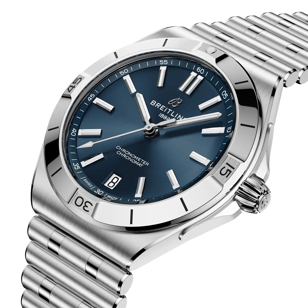 The Breitling Chronomat B31 40 wristwatch features a stainless steel case, blue dial, silver hour markers, date window at 6 o'clock, and signature Rouleaux bracelet, displayed at an angle on a white background.