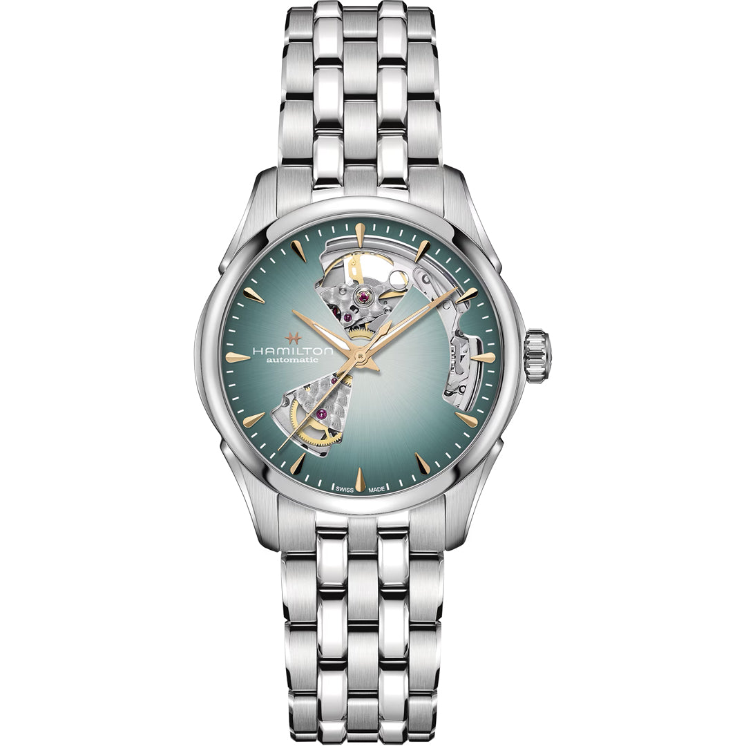 The Hamilton Jazzmaster Open Heart Lady Auto 36mm by Hamilton Watch features a silver case, metallic bracelet, green sunburst dial, gold hands and indices, and open sections revealing the automatic H-10 movement.