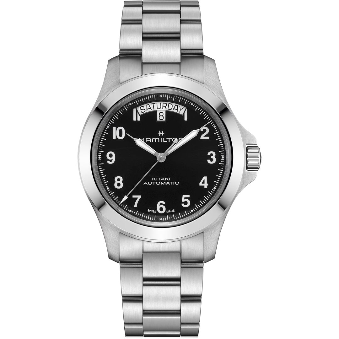 The Hamilton Khaki Field King Auto 40mm Watch by Hamilton Watch features a black dial, silver markers, luminous hands, day-date at 12 o’clock, and comes on a stainless steel bracelet.