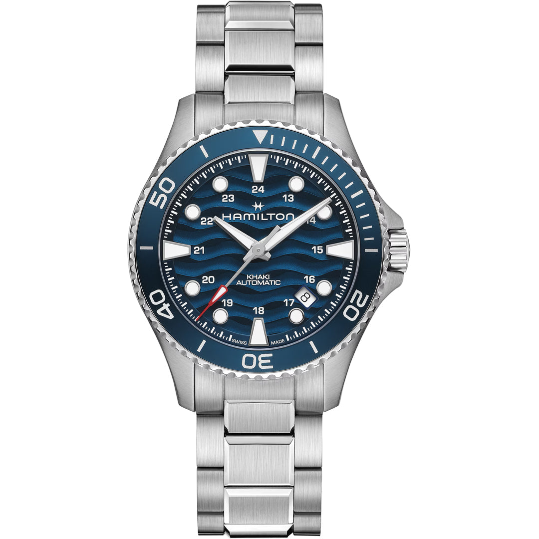 The Hamilton Khaki Navy Scuba Auto 40mm Watch by Hamilton Watch features a silver case, blue dial with silver markers and hands, date window, stainless steel bracelet, and a unidirectional bezel with white markings.