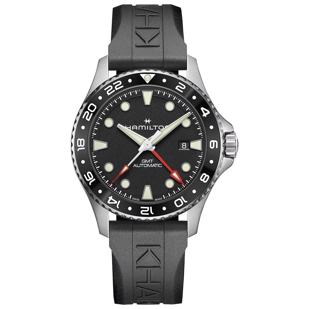 The Hamilton Khaki Navy Scuba Auto GMT 43mm Watch by Hamilton Watch features a black rubber strap, black bezel with white markings, black dial, luminous markers and hands, red GMT hand, and a date window at 3 o’clock.