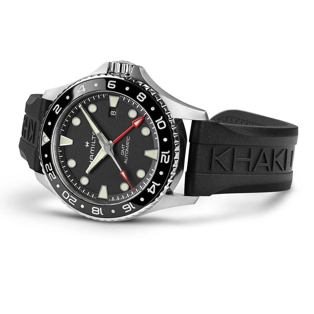 The Hamilton Khaki Navy Scuba Auto GMT 43mm Watch by Hamilton Watch features a black rubber strap embossed with "KHAKI," black bezel, black dial with white markers, silver hands, and a red-tipped second hand—a diving-inspired timepiece.