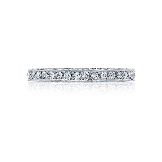 The Tacori Classic Crescent 18K White Gold Round Brilliant Pavé Diamond Anniversary Ring beautifully features a continuous line of small, round diamonds set in a narrow band. Photographed against a white background, this exquisite piece highlights the sparkling brilliance of its diamonds, making it an ideal choice for engagement rings.