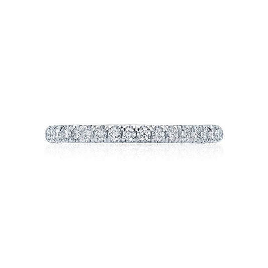 A close-up of the Tacori Petite Crescent Platinum Round Brilliant Diamond Anniversary Ring, featuring a slim design and small encrusted diamonds. Displayed against a white background, it highlights its sparkling and polished appearance—an exquisite choice for an engagement ring.
