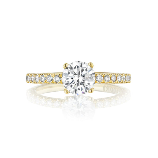 Explore the elegance of the Tacori Petite Crescent engagement ring, crafted in 18K yellow gold. Featuring a stunning round brilliant diamond solitaire at its center, this masterpiece is enhanced with smaller diamonds along the band, embodying sophistication and timeless beauty.