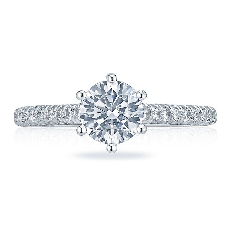 Introducing the Tacori Petite Crescent 18K White Gold Round Brilliant Solitaire Semi Mount with Diamond Band Engagement Ring. This elegant piece showcases a dazzling round-cut diamond in a classic six-prong setting, accented by smaller diamonds on the band. Crafted by expert Tacori gemologists, it offers unparalleled sparkle and sophistication for those seeking an exquisite engagement ring.