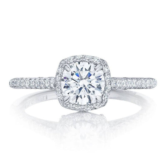 Introducing the Tacori Petite Crescent 18K White Gold Cushion Semi Mount Engagement Ring. This stunning piece features a central round, radiant diamond embraced by a sparkling diamond halo. The band, adorned with Tacori's Signature Crescent details and embellished with small diamonds, exudes an aura of elegance and luxury.