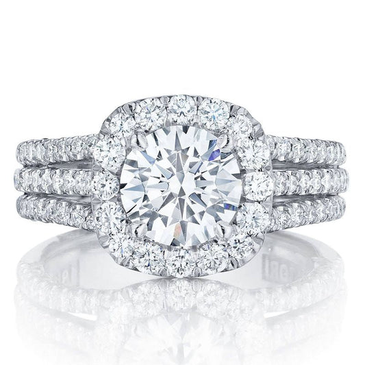 Experience the elegance of Tacori engagement rings with the Tacori Petite Crescent 18K White Gold Cushion Semi Mount Engagement Ring. This exquisite piece features a dazzling round central diamond encircled by a halo of smaller diamonds, complemented by a band adorned with three rows of diamond accents, embodying luxury and sophistication.
