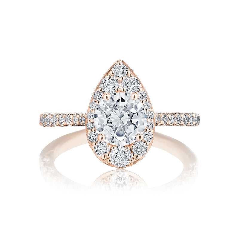 The Tacori Petite Crescent 18K Rose Gold Round Brilliant Semi Mount with Diamond Band and Halo Engagement Ring by Tacori boasts a stunning design, featuring a central stone encircled by a halo of smaller diamonds. The band, adorned with Signature Crescent accents, is set with additional diamonds in rose gold, beautifully reflecting light for a dazzling effect.