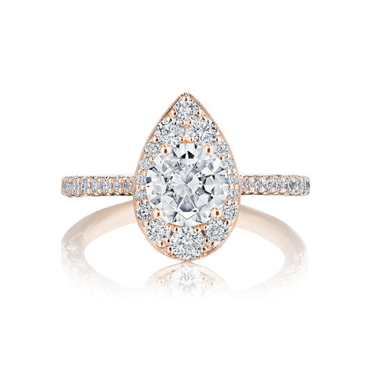 The Tacori Petite Crescent 18K Rose Gold Round Brilliant Semi Mount with Diamond Band and Halo Engagement Ring by Tacori boasts a stunning design, featuring a central stone encircled by a halo of smaller diamonds. The band, adorned with Signature Crescent accents, is set with additional diamonds in rose gold, beautifully reflecting light for a dazzling effect.