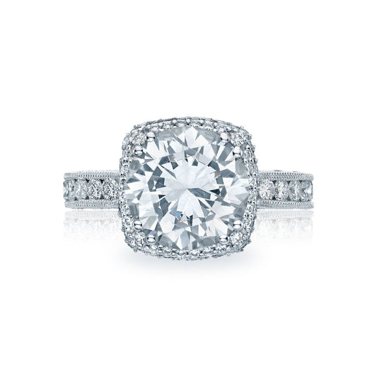 The Tacori Classic Crescent RoyalT Platinum Round Brilliant Semi Mount with Diamond Band and Halo Engagement Ring boasts an exquisite design, featuring a brilliant center stone framed by a halo and set on a band adorned with smaller diamonds that enhance its radiance. The G color diamonds from the Tacori brand elevate the ring's luminous elegance.