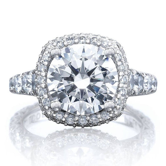 The Tacori Petite Crescent RoyalT Platinum Cushion Semi Mount with Diamond Band and Halo Engagement Ring by Tacori features a stunning princess-bloomed center stone encircled by a halo of smaller diamonds. The platinum band, embellished with additional G color VS clarity diamonds, amplifies the ring's brilliance and sophistication.